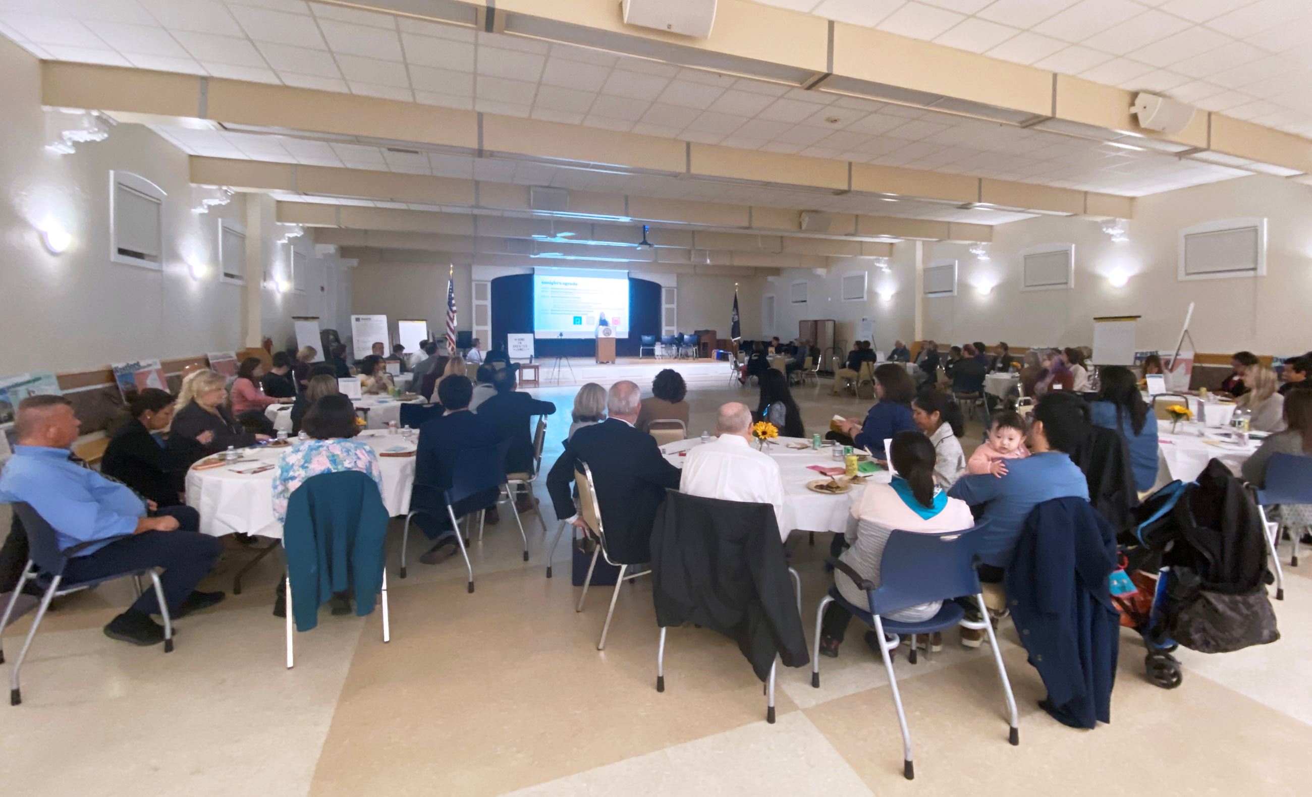 People sitting around tables at a conference