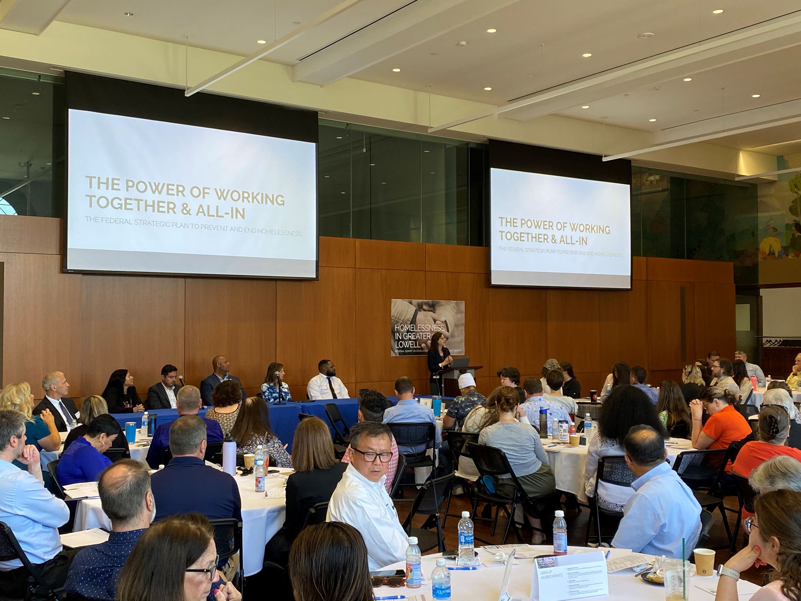 A group of people at tables in a summit